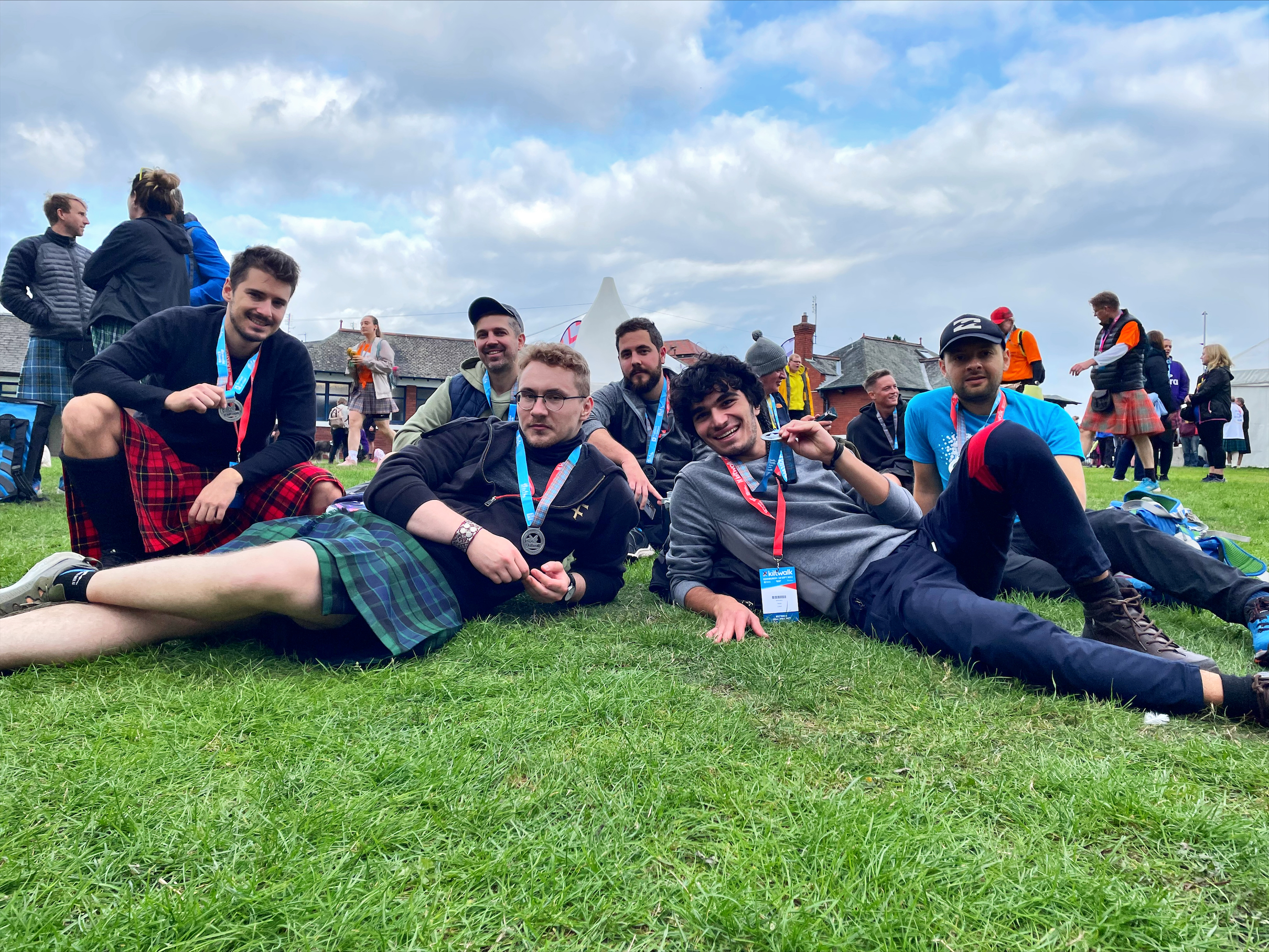 The IGC kiltwalk team rest on the grass