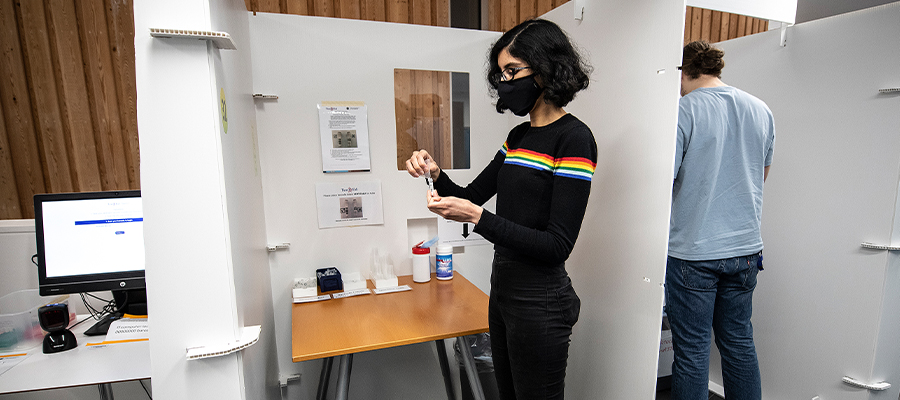 Girl providing a saliva sample for Covid-19 testing through the TestEd research programme